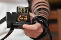 Jewish Man wrapped in tefillin pray . A religious orthodox with arm-tefillin on his left hand prays