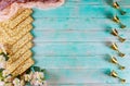 Jewish matzah bread on blue background with six wine cups and flowers. Passover holiday concept Royalty Free Stock Photo