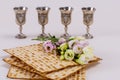 Jewish matzah bread on white background with four wine cups. Passover holiday concept Royalty Free Stock Photo