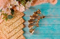 Jewish matzah bread on wooden background with six wine cups and flowers. Passover holiday concept Royalty Free Stock Photo