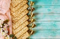 Jewish matzah bread on wooden background with six wine cups and flowers. Passover holiday concept Royalty Free Stock Photo