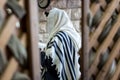 Jewish men praying in a synagogue with Tallit