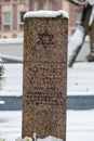 Jewish monument, Star of David engraved on a marble stone covered by the snow