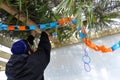 Jewish Orthodox man decorating a Sukkah