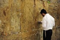 Jewish orthodox man praying at the western wall