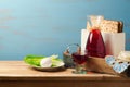 Jewish Passover holiday concept with wine, matzoh, egg and lettuce over wooden background with copy space Royalty Free Stock Photo