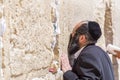 Jewish people praying against the Western Wall in Jerusalem