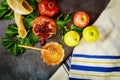 Jewish prayer talit with traditional food for rosh hashanah