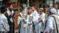 Jewish rabbi hasid surrounded by a crowd of pilgrims blows Shofar. Rosh Hashanah, Jewish New Year.