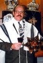 Jewish rabbi poses for a photo inside a synagogue