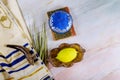 Jewish ritual festival of Sukkot in the jewish religious symbol Etrog, lulav, hadas, arava tallit praying book kippah and shofar Royalty Free Stock Photo