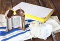 Jewish torah and talit on wooden table