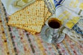 Jewish traditional Passover unleavened bread and a wine cup with the text of the traditional wine blessing