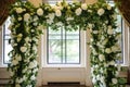 jewish wedding chuppah adorned with white roses and green leaves