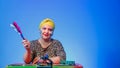 A Jewish woman in a headdress with a Magen David painted face directs the noise on Purim while reading