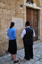 Jewish woman and a read the inscription on the wall