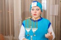 A Jewish woman in a kisui rosh headdress with a Chanukah candlestick with lighted candles in her hands is looking for an Royalty Free Stock Photo