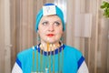 A Jewish woman in a kisui rosh headdress with a Chanukah candlestick with lighted candles in her hands is looking for an Royalty Free Stock Photo