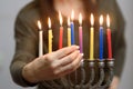 Jewish Woman lighting Hanukkah Candles in a menorah. Royalty Free Stock Photo