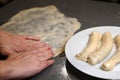 Jewish woman preparing Jachnun in home kitchen