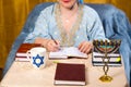 A Jewish woman teacher of the Torah conducts a lesson for women on the commandments.