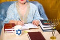 A Jewish woman teacher of the Torah conducts a lesson for women on the commandments.