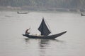 jhalokathi, Bangladesh-February 06,2020: An old Boatman collecting plastic bottles from river in Padma river Royalty Free Stock Photo