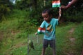 Little child holding Indian National Tricolor Flag with an older. Indian Independence Day or