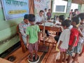 a doctors check up a students body at a primary school in rural india