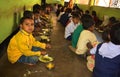 Mid day meal program, an Indian government initiative, is being running in a primary school. Pupils are taking their meal