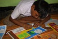 Jhargram, West Bengal, India - September 25, 2019: A poor Indian primary school boy drawing in a Sit and draw compitition Royalty Free Stock Photo