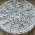 JHS Christogram of the stone above the lateral entrance of church of San Francesco, Scutari