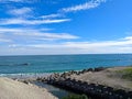 Jian Stream leading to the Pacific Ocean via a beach with tetrapods on the side and people enjoying the beach on a sunny Royalty Free Stock Photo