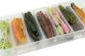 Jig silicone fishing lures in plastic tackle lure box. Silicone fishing baits isolated. Colorful baits. Fishing spinning bait. Royalty Free Stock Photo