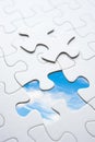 Jigsaw piece with sky in hole, conceptual image Royalty Free Stock Photo