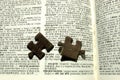 Jigsaw pieces on a dictionary
