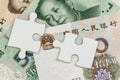 2 jigsaw puzzle on Chinese Yuan banknotes using as China economics, tariff or trade war negotiation future direction between the