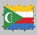Jigsaw puzzle of Comoros flag in yellow white red and blue with green chevron, crescent and star.