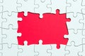 Jigsaw puzzle game piece on red background for business theme design Royalty Free Stock Photo