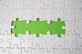 Jigsaw puzzle on green background, business teamwork, problem solving concept Royalty Free Stock Photo