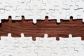 Jigsaw Puzzle with Missing Pieces Revealing Wooden Background Royalty Free Stock Photo