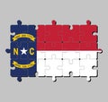 Jigsaw puzzle of North Carolina flag in blue union, a white star with N and C, the circle containing the same to be one-third.