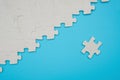 Jigsaw puzzle with one piece separated on blue background Royalty Free Stock Photo