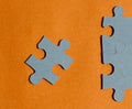 Jigsaw puzzle pieces on bright orange background Royalty Free Stock Photo