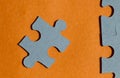 Jigsaw puzzle pieces on bright orange background Royalty Free Stock Photo