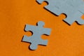 Jigsaw puzzle pieces on bright orange background Royalty Free Stock Photo