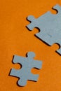 Jigsaw puzzle pieces on bright orange background Royalty Free Stock Photo