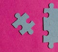 Jigsaw puzzle pieces on bright pink background Royalty Free Stock Photo