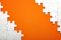 Jigsaw puzzle pieces and business concept with a border made of puzzle pieces on colorful bright orange background with copy space Royalty Free Stock Photo