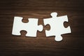 Jigsaw puzzle pieces that match on a wooden background Royalty Free Stock Photo